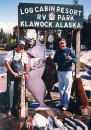 Captain, Skip Fabry, with a satisfied fishing charter guest holding a 330 lb. Halibut